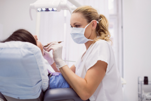 Female dentist with patient in chair 