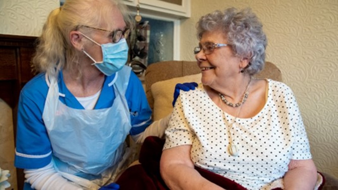 social care worker with patient at home