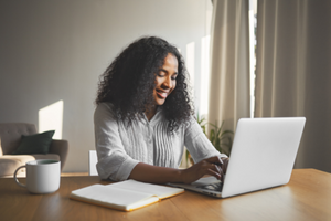 Lady Smiling On Laptop