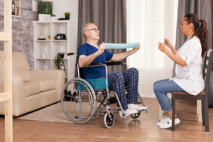 Physio Working With Patient In Their Home