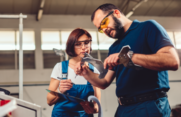 Female engineering apprentice learning from mentor 